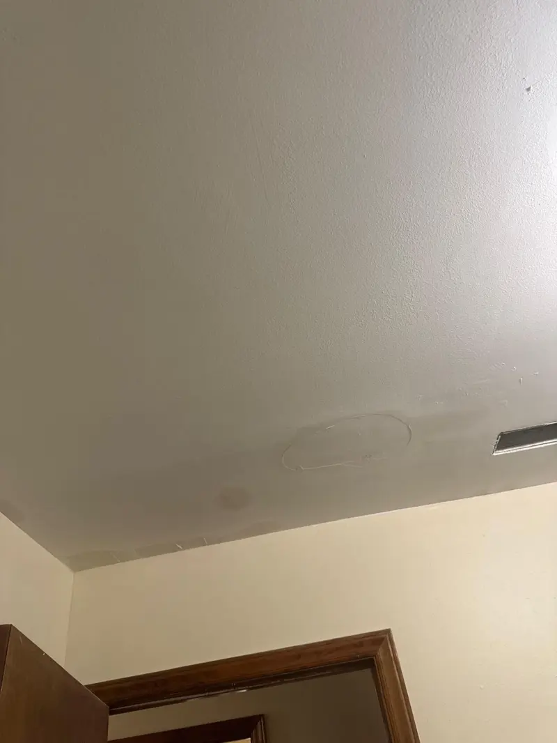 Patched drywall ceiling section before priming and painting